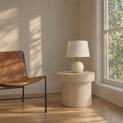Cream ceramic table lamp with a leaf-embroidered shade, room view