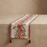 Decorative table runner with floral and bird pattern on a beige surface