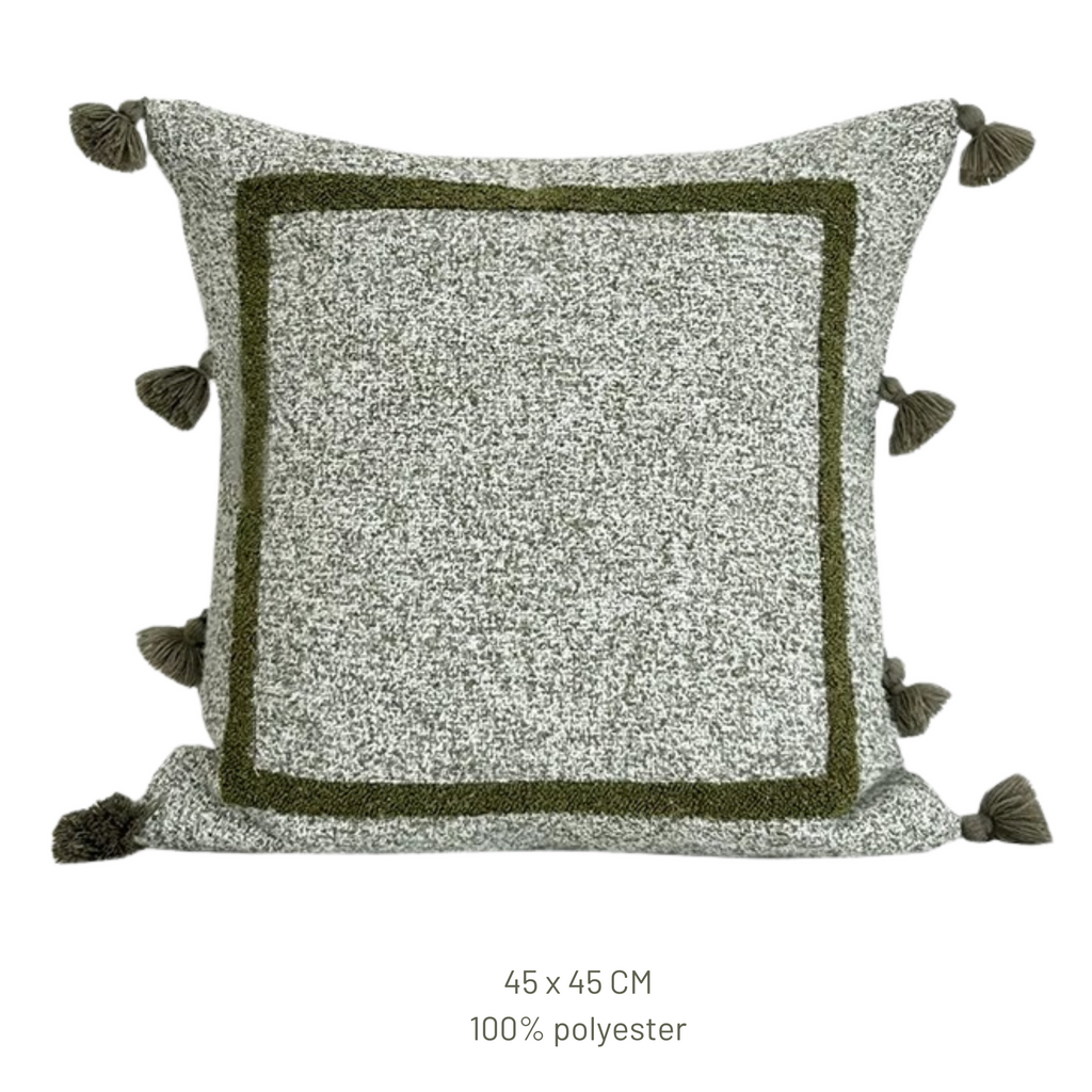 Decorative pillow with pom-pom details on a white background, featuring the Beacon brand.