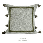 Decorative pillow with pom-pom details on a white background, featuring the Beacon brand.