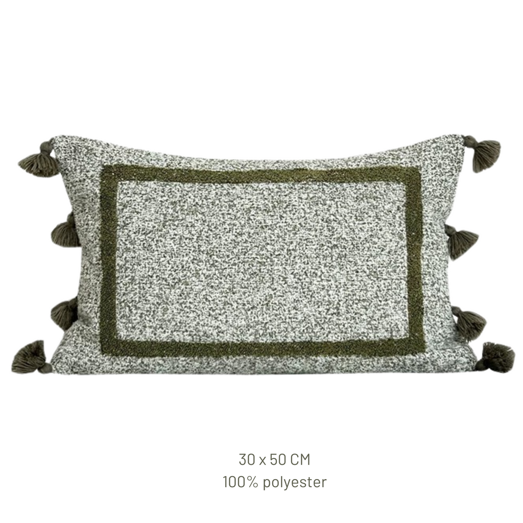 Decorative pillow with tassels on a white background, featuring the Beacon brand.