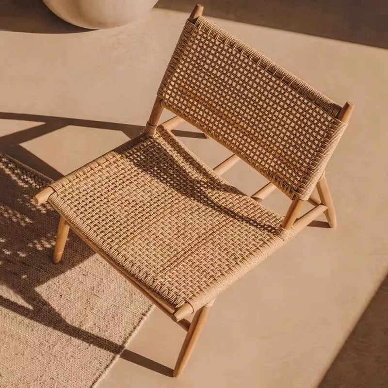Woven chair on a textured surface with warm lighting