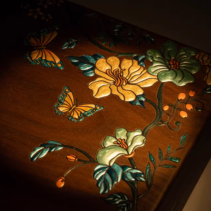 Wooden surface with floral and butterfly carvings