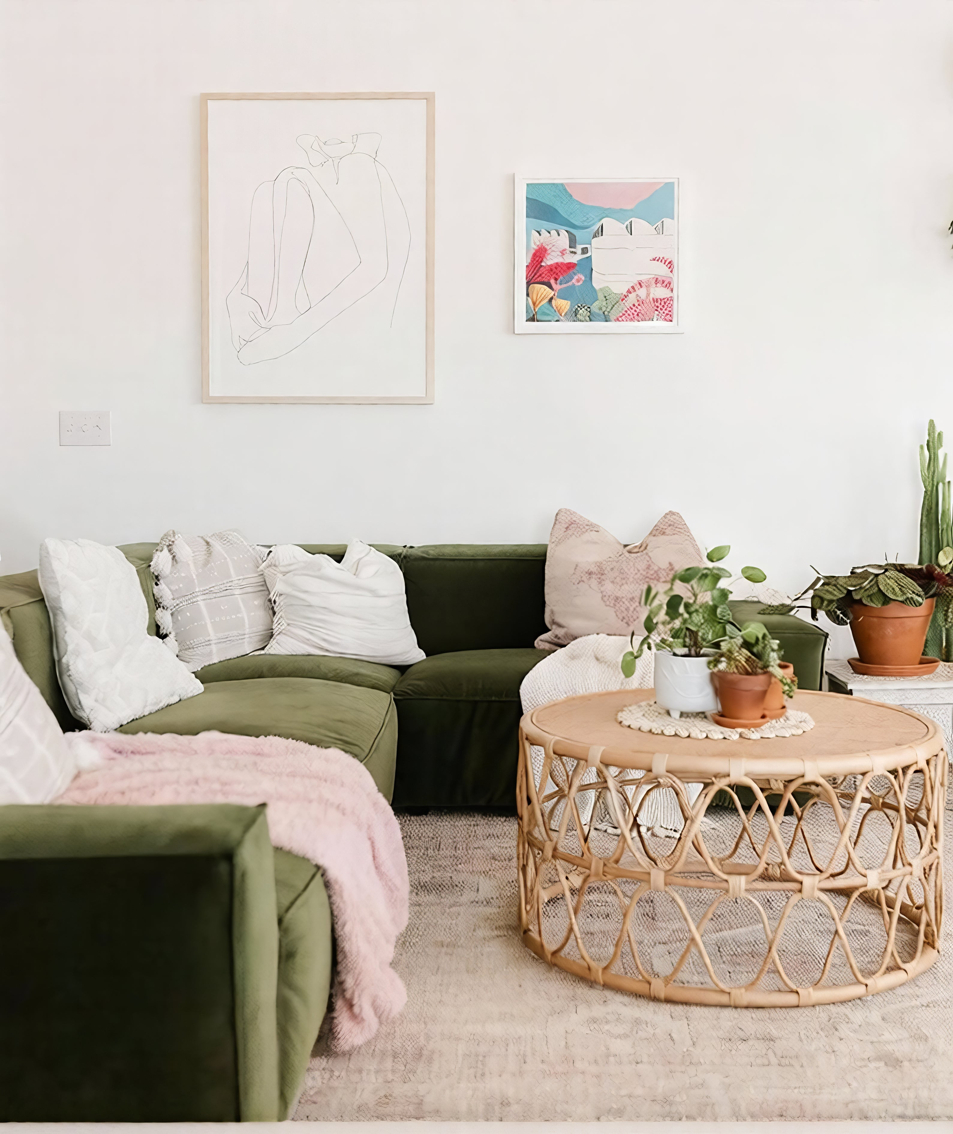 Living room with green sectional sofa, wooden coffee table, and decorative plants.