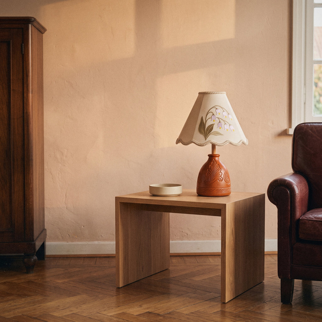 Lily of the Valley table lamp with embroidered shade and carved wood base, in a room