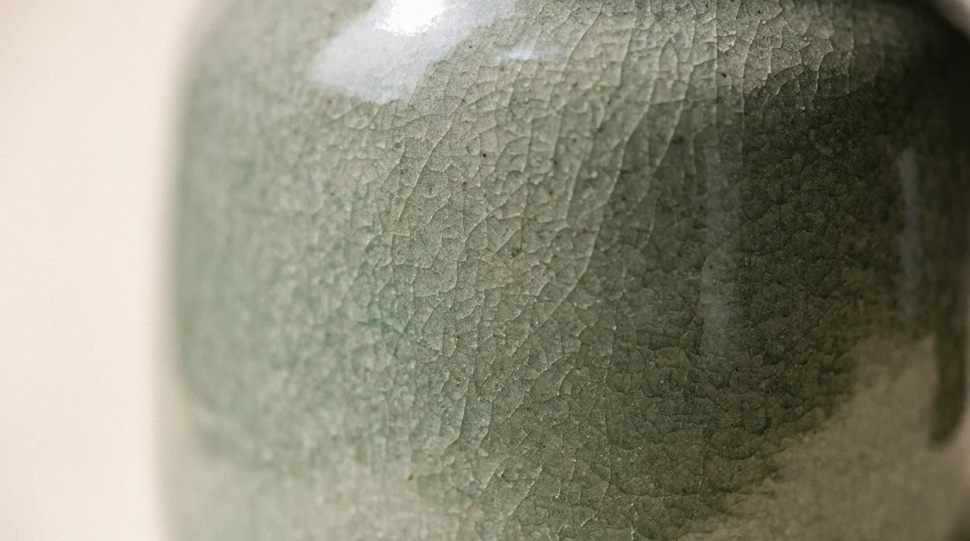 Close-up of a green crackle glaze on a ceramic jar